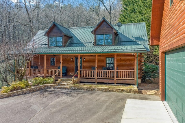 log cabin featuring covered porch