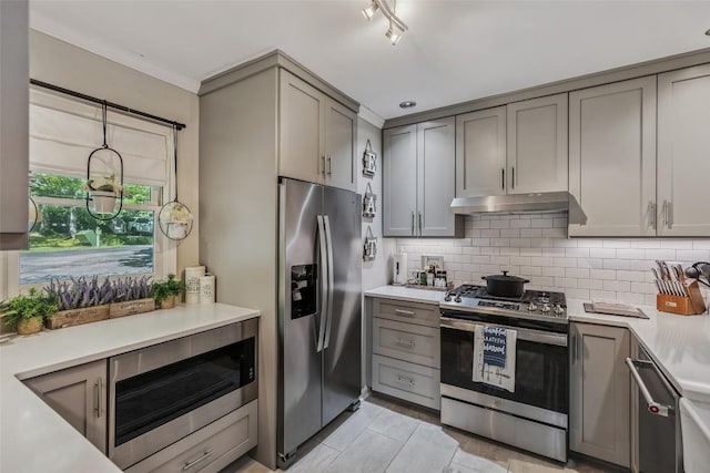 27 Dwarf Mountain Rd Unit 23Un, Sapphire, NC 28774 - kitchen featuring appliances with stainless steel finishes, gray cabinetry, under cabinet range hood, tasteful backsplash, and ornamental molding