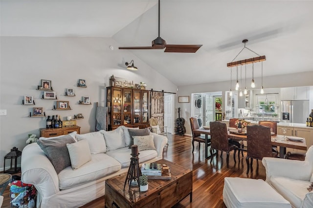 27 Dwarf Mountain Rd Unit 23Un, Sapphire, NC 28774 - living room with stacked washing machine and dryer, vaulted ceiling, dark wood-style floors, and ceiling fan