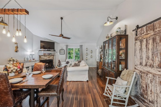 27 Dwarf Mountain Rd Unit 23Un, Sapphire, NC 28774 - dining space with vaulted ceiling, a fireplace, wood finished floors, a barn door, and a ceiling fan