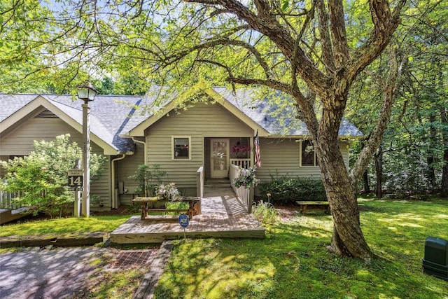 27 Dwarf Mountain Rd Unit 23Un, Sapphire, NC 28774 - view of front of house with a front yard, a shingled roof, and a deck