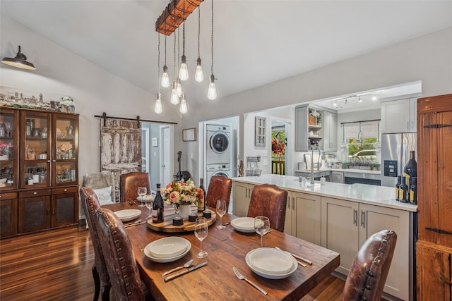 27 Dwarf Mountain Rd Unit 23Un, Sapphire, NC 28774 - dining space featuring stacked washer / drying machine, a barn door, vaulted ceiling, and dark wood-type flooring
