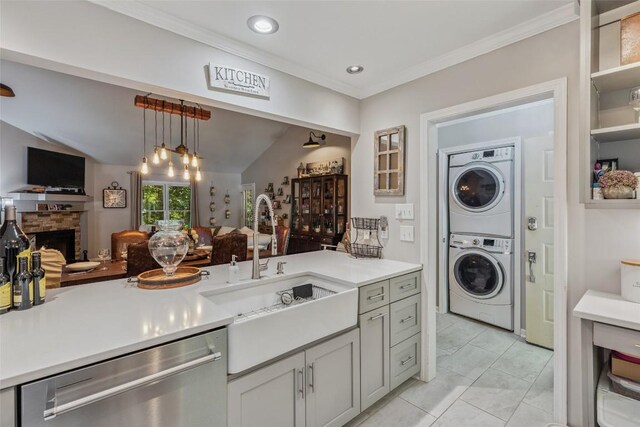 27 Dwarf Mountain Rd Unit 23Un, Sapphire, NC 28774 - kitchen featuring stainless steel dishwasher, stacked washer / drying machine, open floor plan, light countertops, and a fireplace