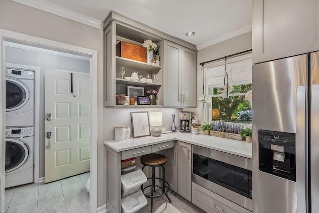 27 Dwarf Mountain Rd Unit 23Un, Sapphire, NC 28774 - kitchen featuring stainless steel appliances, estacked washer and dryer, ornamental molding, gray cabinets, and light countertops