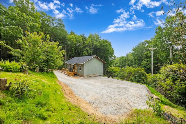 185 Little Elbow Mountain Rd, Lake Toxaway, NC 28747 - view of front of home featuring a view of trees, a deck, an outbuilding, and driveway