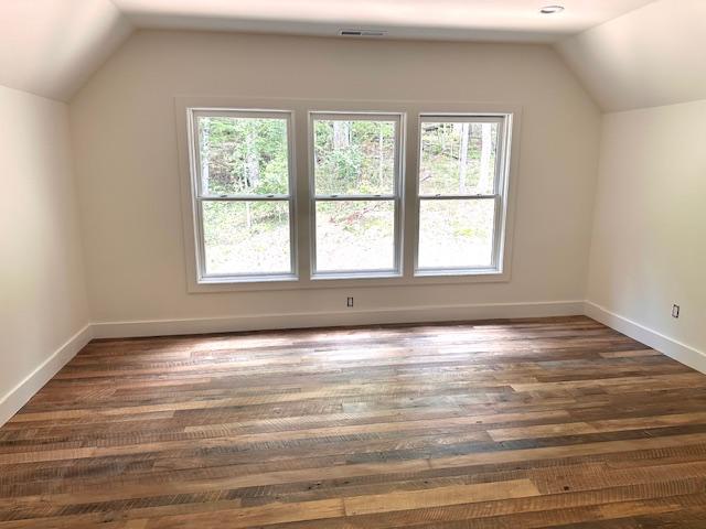 298 Pine Forest Rd, Sapphire, NC 28774 - bonus room with lofted ceiling, healthy amount of natural light, and wood finished floors