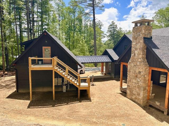 298 Pine Forest Rd, Sapphire, NC 28774 - back of property with stairs, board and batten siding, and a chimney