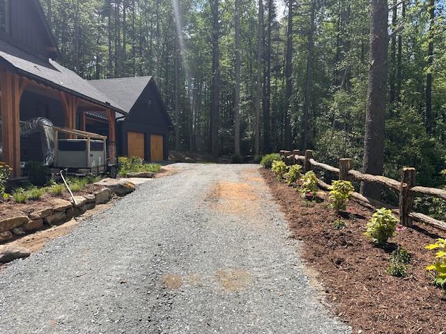 298 Pine Forest Rd, Sapphire, NC 28774 - view of dirt / gravel driveway with a forest view