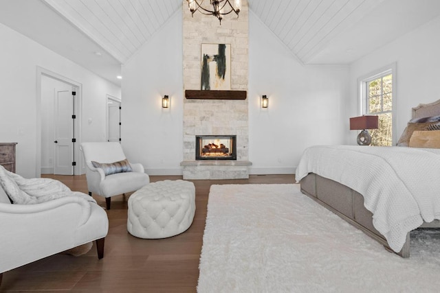 343 Ledgeview Rd, Cashiers, NC 28717 - bedroom with lofted ceiling, wood finished floors, a multi sided fireplace, a chandelier, and wooden ceiling
