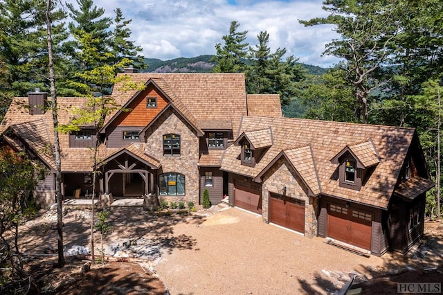 view of front facade with a garage and a mountain view