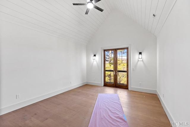 empty room featuring ceiling fan, light wood-type flooring, and high vaulted ceiling