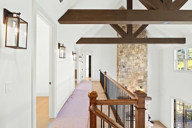 corridor featuring vaulted ceiling with beams