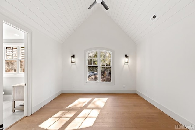 empty room with wood ceiling, ceiling fan, vaulted ceiling, and light wood-type flooring