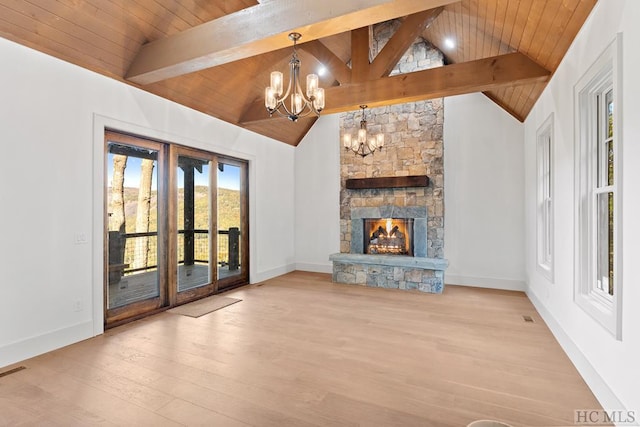 unfurnished living room featuring wood ceiling, a fireplace, a chandelier, and vaulted ceiling with beams