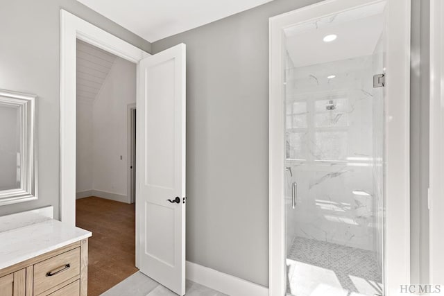 bathroom with vanity, hardwood / wood-style floors, and a shower with shower door