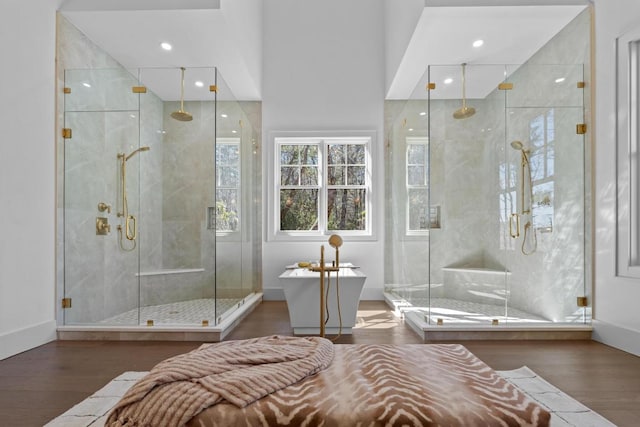 343 Ledgeview Rd, Cashiers, NC 28717 - bathroom featuring wood finished floors, a freestanding tub, a stall shower, baseboards, and recessed lighting