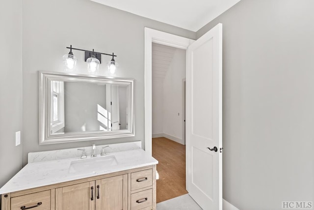 bathroom with vanity and hardwood / wood-style flooring