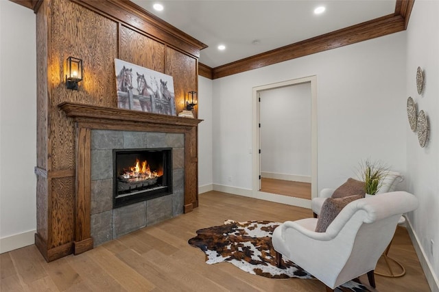 343 Ledgeview Rd, Cashiers, NC 28717 - sitting room with ornamental molding, a fireplace, baseboards, light wood finished floors, and recessed lighting