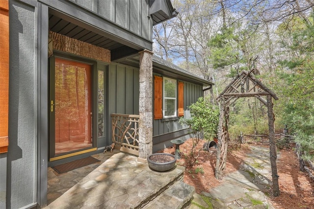 view of exterior entry featuring board and batten siding