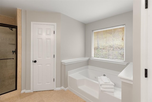 full bath featuring baseboards, a shower stall, and a garden tub