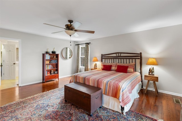 bedroom with visible vents, baseboards, and wood finished floors