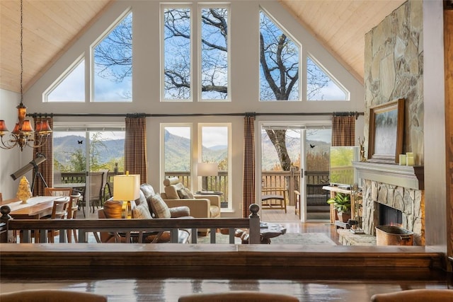 sunroom featuring an inviting chandelier and a mountain view