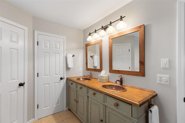 full bathroom with a sink, tile patterned floors, and double vanity