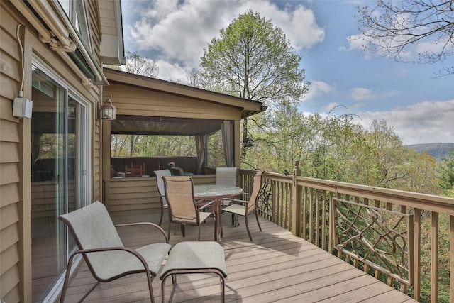 wooden deck featuring outdoor dining area