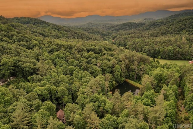 aerial view at dusk featuring a mountain view