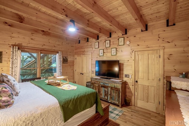 bedroom with beam ceiling, light hardwood / wood-style flooring, access to exterior, wood ceiling, and wooden walls