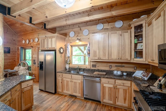 kitchen featuring stainless steel appliances, wood walls, wooden ceiling, sink, and light wood-type flooring