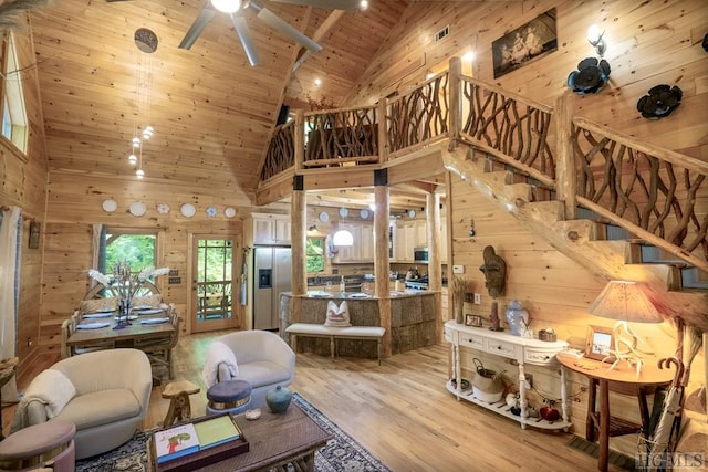 living room featuring ceiling fan, wooden ceiling, hardwood / wood-style floors, and wooden walls