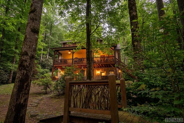 rear view of property with a wooden deck