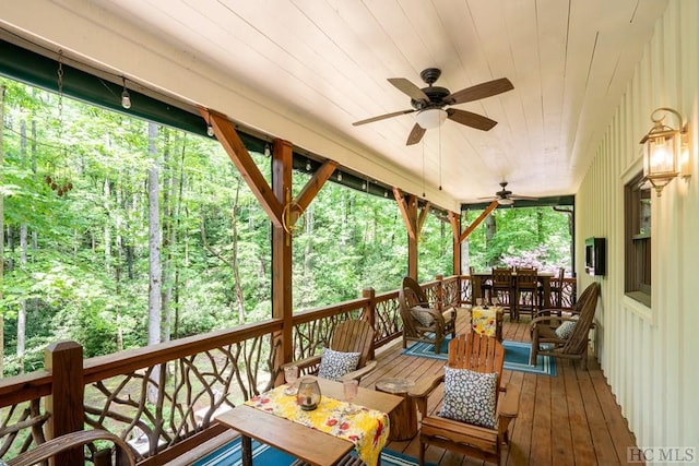 wooden terrace featuring ceiling fan