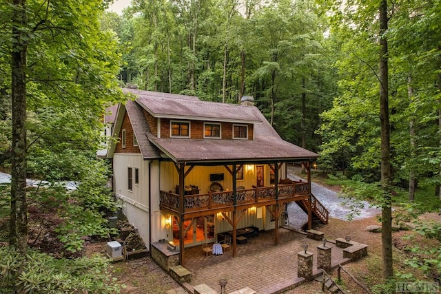 view of front of property featuring a deck and a patio area