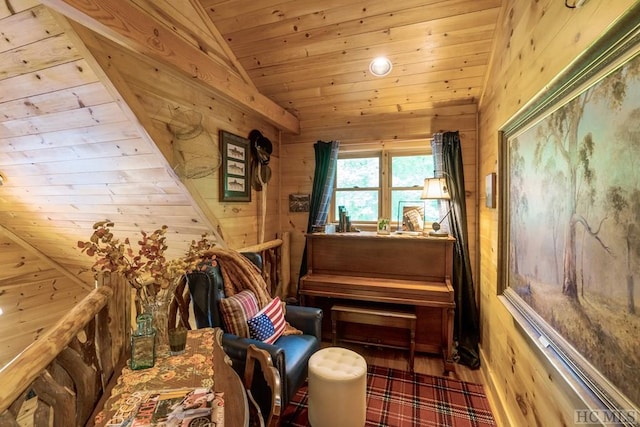 living area with hardwood / wood-style flooring, vaulted ceiling, wooden ceiling, and wood walls