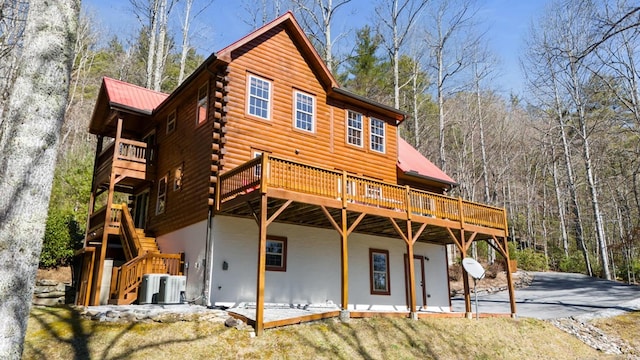 back of property featuring central air condition unit, a patio, and a wooden deck