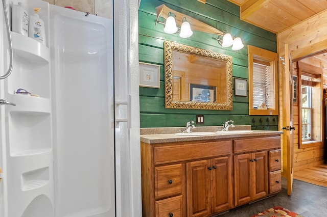 bathroom featuring vanity, walk in shower, wood walls, and wood ceiling