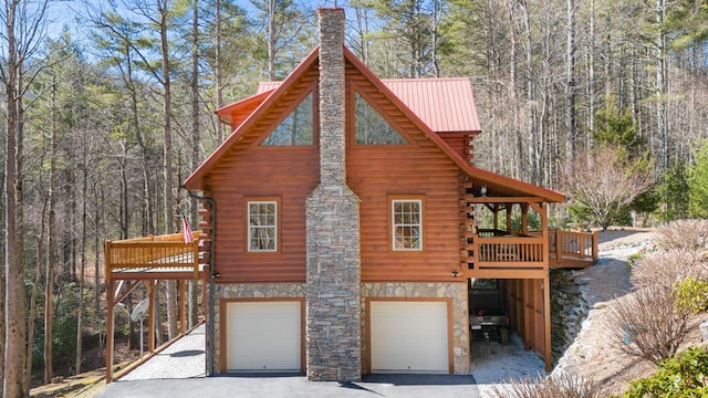 exterior space with a garage and a wooden deck