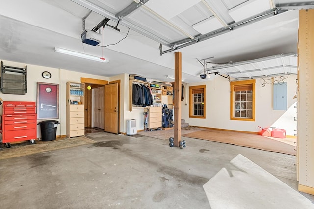 garage with a garage door opener and electric panel