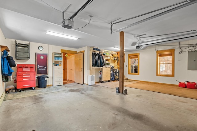 garage featuring electric panel and a garage door opener