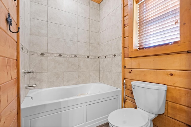 bathroom with toilet and a bathing tub