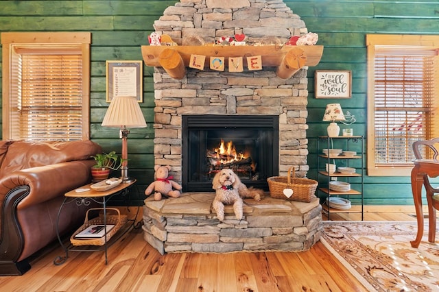 living room featuring hardwood / wood-style floors and a stone fireplace