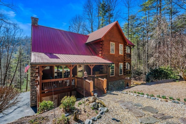 log-style house featuring a porch