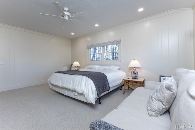 carpeted bedroom featuring ornamental molding and ceiling fan