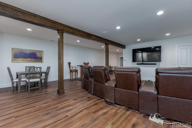 home theater featuring beam ceiling, recessed lighting, baseboards, and wood finished floors