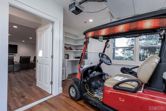 garage with a garage door opener and recessed lighting