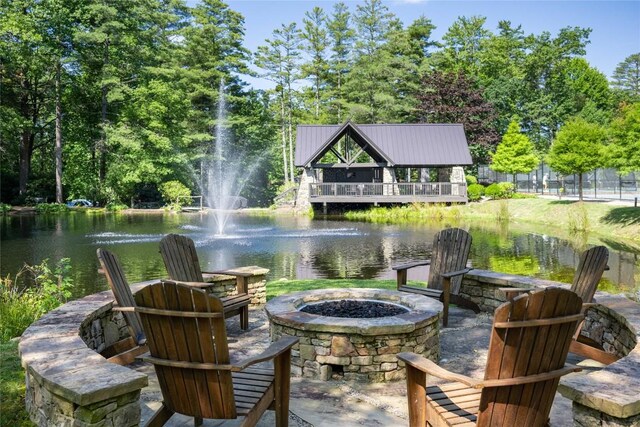 view of patio / terrace featuring a water view and an outdoor fire pit