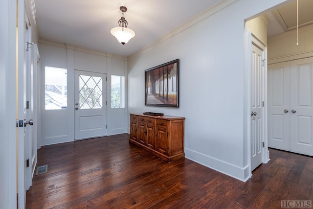 entryway with baseboards, dark wood-style floors, visible vents, and ornamental molding