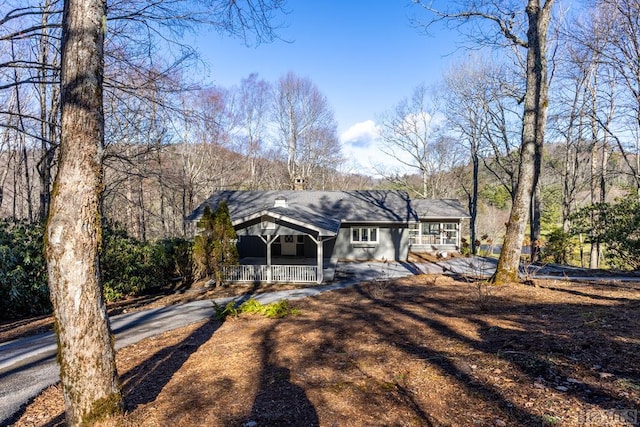 rear view of property with covered porch